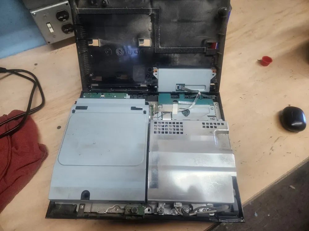 Fat PS3 with the top shell lifted off, Blu-ray drive on the left and the power supply on the right