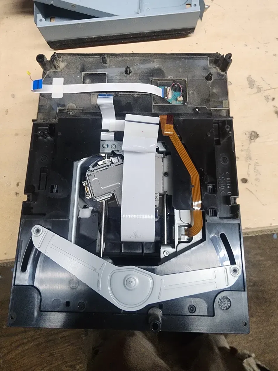 Inside the PS3 Blu-ray drive: laser sled, rails and ribbon cables