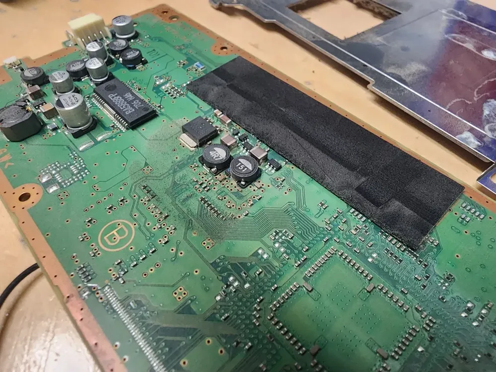PS3 motherboard section with dust around the voltage regulators and coils
